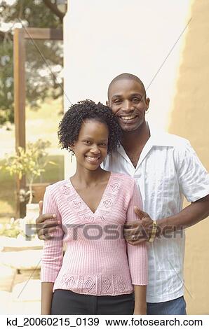 Young African couple smiling outdoors View Large Photo Image Stock Photo - Young African couple smiling outdoors. Fotosearch