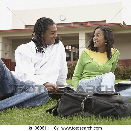 Young African couple studying in grass View Large Photo Image Stock Photo - Young African couple studying in grass. Fotosearch