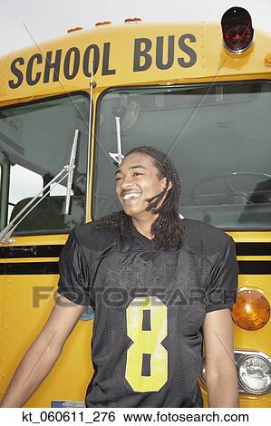 Young African man in football uniform next to school bus View Large Photo Image Stock Photograph - Young African man in football uniform next to school bus. Fotosearch