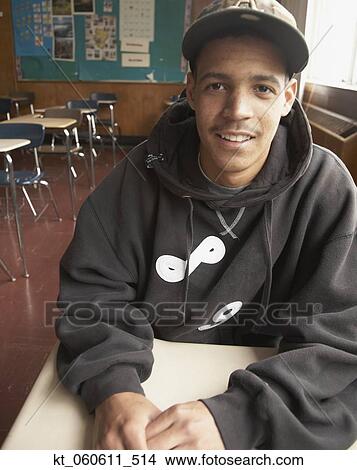 Young African man sitting in classroom View Large Photo Image Picture - Young African man sitting in classroom. Fotosearch
