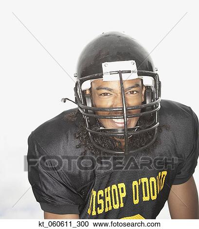 Stock Image - Young African man wearing football uniform. Fotosearch