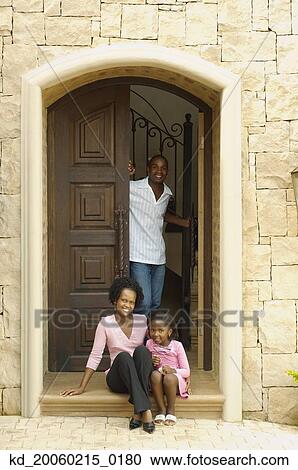 Stock Image - Young African parents with daughter in doorway. Fotosearch