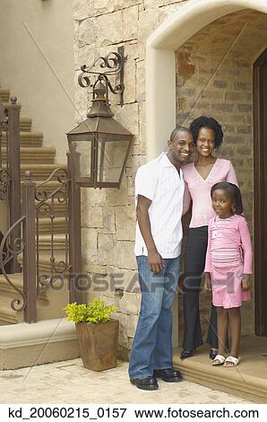 Young African parents with daughter in entrance of house View Large Photo Image Stock Photo - Young African parents with daughter in entrance of house. Fotosearch