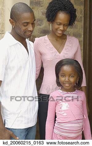 Stock Image - Young African parents with daughter smiling. Fotosearch