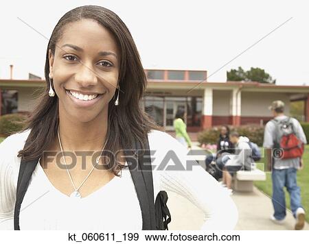 Stock Photo - Young African woman smiling on school campus. Fotosearch