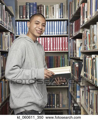 Young Asian man in library View Large Photo Image Stock Image - Young Asian man in library. Fotosearch