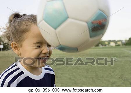 Young girl bouncing soccer ball off head View Large Photo Image Stock Image - Young girl bouncing soccer ball off head. Fotosearch