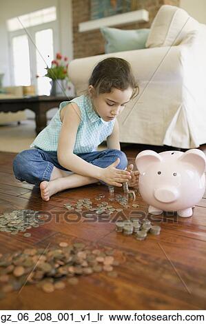 Young girl counting money next to piggy bank View Large Photo Image Stock Photography - Young girl counting money next to piggy bank. Fotosearch