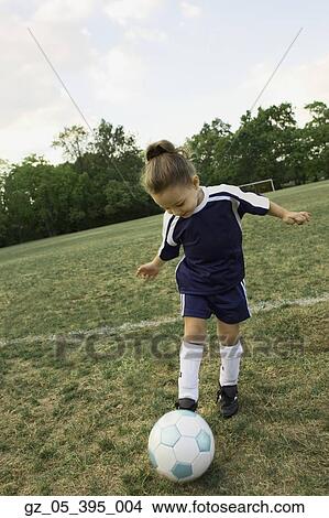 Picture - Young girl in athletic gear playing soccer . Fotosearch