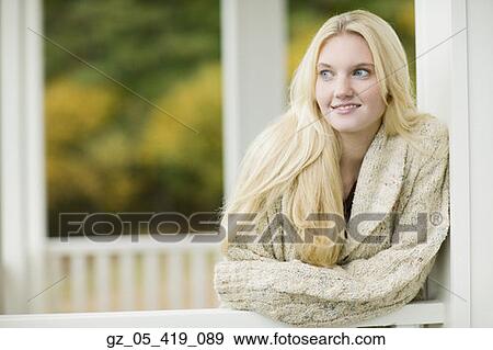 Young woman leaning on porch railing outdoors View Large Photo Image Stock Photo - Young woman leaning on porch railing outdoors. Fotosearch
