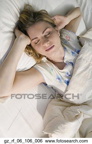 Young woman sleeping in bed View Large Photo Image Stock Photograph - Young woman sleeping in bed. Fotosearch