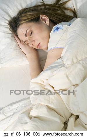 Young woman sleeping in bed View Large Photo Image Stock Photography - Young woman sleeping in bed. Fotosearch
