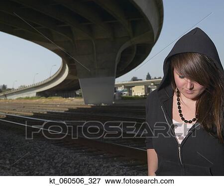 Young woman standing under raised highway View Large Photo Image Stock Photo - Young woman standing under raised highway. Fotosearch