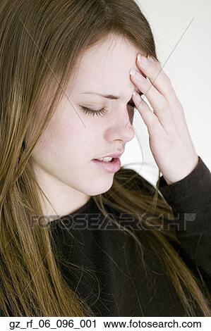 Young woman touching forehead with eyes closed View Large Photo Image Stock Image - Young woman touching forehead with eyes closed. Fotosearch