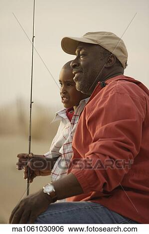 African father and son on beach with fishing gear View Large Photo Image Stock Photograph - African father and son on beach with fishing gear. Fotosearch