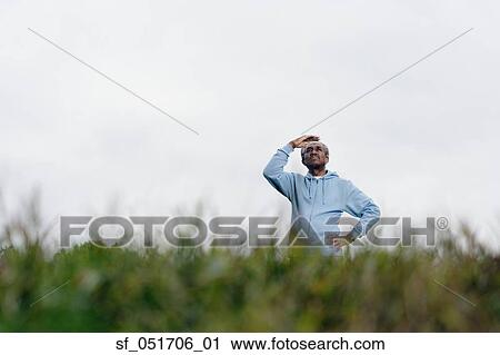 African man shading eyes with hand outdoors View Large Photo Image Stock Image - African man shading eyes with hand outdoors. Fotosearch