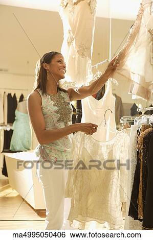 African woman shopping at clothing store View Large Photo Image Stock Photograph - African woman shopping at clothing store. Fotosearch