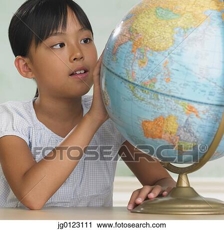 Asian girl looking at globe View Large Photo Image Stock Image - Asian girl looking at globe. Fotosearch