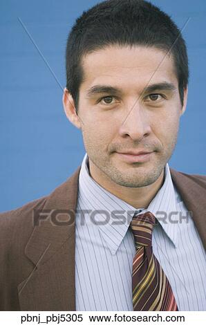 Stock Photography - Close up of Hispanic businessman smiling. Fotosearch