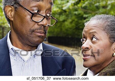 Stock Photo - Close up of senior African couple looking at each other outdoors. Fotosearch