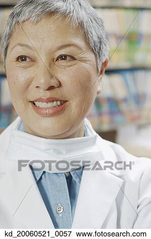 Close up of senior Asian female dentist smiling View Large Photo Image Stock Photo - Close up of senior Asian female dentist smiling. Fotosearch