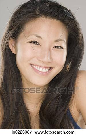 Close up of young Asian woman smiling View Large Photo Image Stock Photo - Close up of young Asian woman smiling. Fotosearch