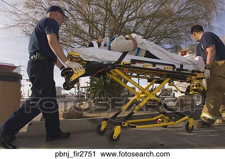 EMT workers with accident victim on gurney View Large Photo Image Stock Image - EMT workers with accident victim on gurney. Fotosearch
