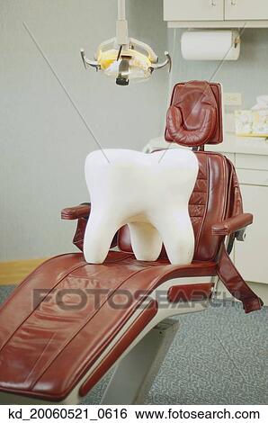 Stock Photograph - Giant tooth sitting on dentist's chair. Fotosearch