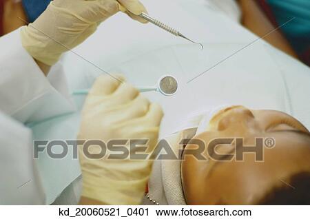High angle view of dentist working on African boy View Large Photo Image Stock Image - High angle view of dentist working on African boy. Fotosearch