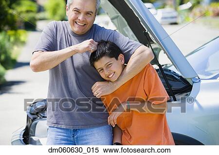 Hispanic father and son playing in front of car with hood up View Large Photo Image Stock Photography - Hispanic father and son playing in front of car with hood up. Fotosearch