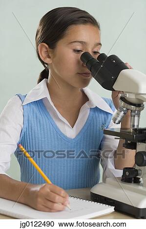 Hispanic girl looking through microscope View Large Photo Image Stock Image - Hispanic girl looking through microscope. Fotosearch