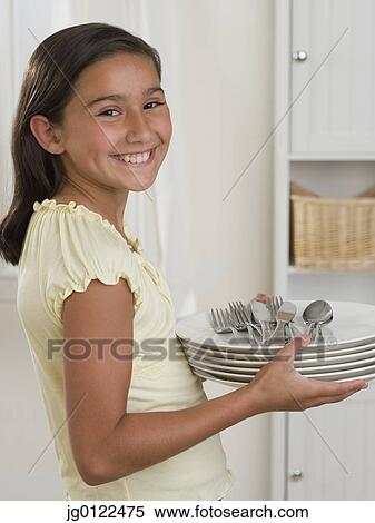 Hispanic girl smiling with stack of plates and silverware View Large Photo Image Stock Photography - Hispanic girl smiling with stack of plates and silverware. Fotosearch