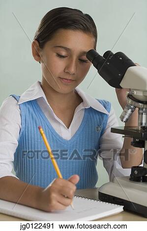 Hispanic girl with microscope and notebook View Large Photo Image Stock Image - Hispanic girl with microscope and notebook. Fotosearch