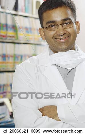 Indian male dentist smiling in office View Large Photo Image Stock Photo - Indian male dentist smiling in office. Fotosearch