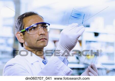 Indian male scientist looking at DNA film View Large Photo Image Stock Image - Indian male scientist looking at DNA film. Fotosearch