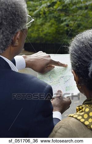 Senior African couple looking at map outdoors View Large Photo Image Stock Photograph - Senior African couple looking at map outdoors. Fotosearch
