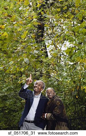 Senior African couple pointing in woods View Large Photo Image Stock Image - Senior African couple pointing in woods. Fotosearch