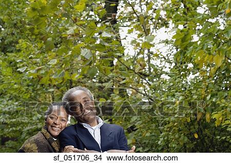 Picture - Senior African couple smiling in woods. Fotosearch