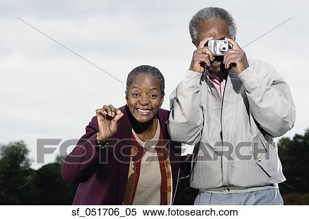 Senior African couple taking photograph outdoors View Large Photo Image Stock Photography - Senior African couple taking photograph outdoors. Fotosearch