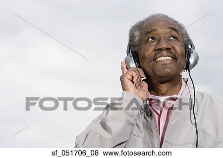 Senior African man wearing headphones View Large Photo Image Stock Photo - Senior African man wearing headphones. Fotosearch