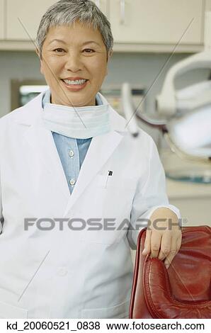 Senior Asian female dentist smiling View Large Photo Image Stock Photo - Senior Asian female dentist smiling. Fotosearch