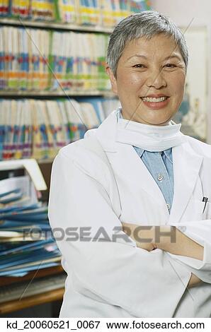 Senior female Asian dentist in office View Large Photo Image Stock Photo - Senior female Asian dentist in office. Fotosearch
