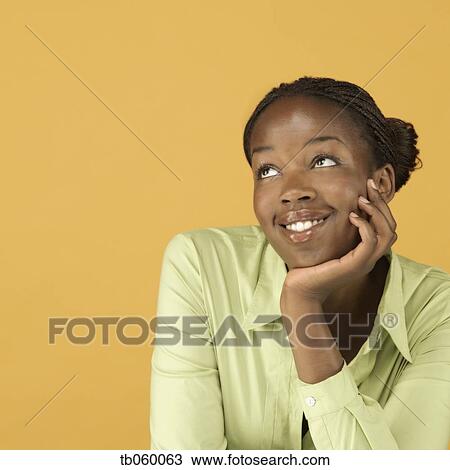 Stock Image - Studio shot of African woman smiling. Fotosearch