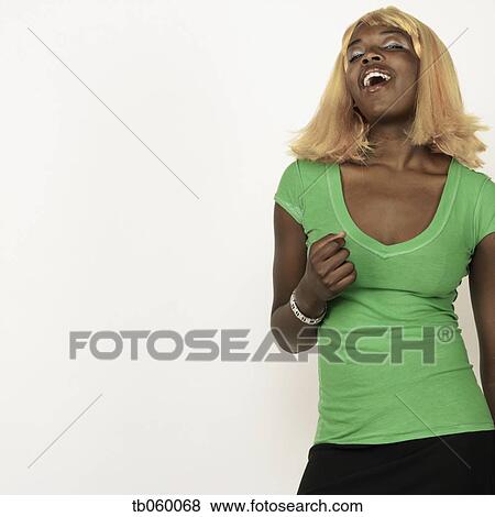 Stock Photo - Studio shot of African woman wearing blonde wig. Fotosearch