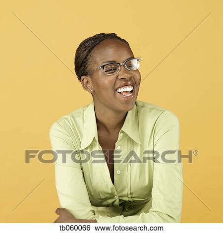Studio shot of African woman wearing eyeglasses and smiling View Large Photo Image Stock Photograph - Studio shot of African woman wearing eyeglasses and smiling. Fotosearch