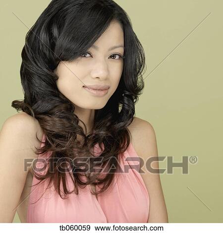 Stock Photo - Studio shot of Asian woman smiling. Fotosearch