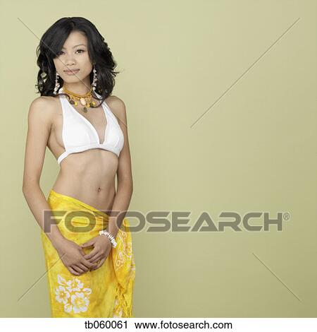 Stock Image - Studio shot of Asian woman wearing beach sarong. Fotosearch