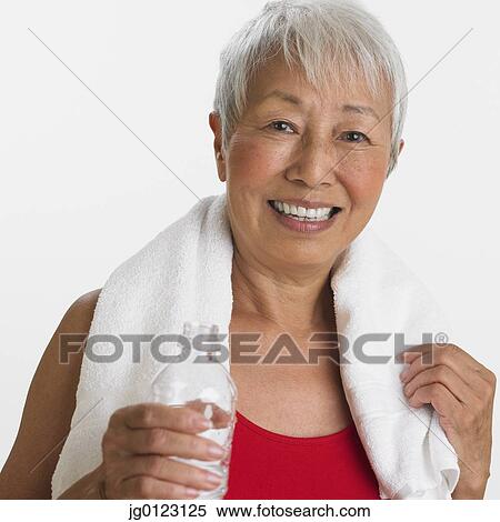 Studio shot of senior Asian woman with water and towel View Large Photo Image Stock Photography - Studio shot of senior Asian woman with water and towel. Fotosearch