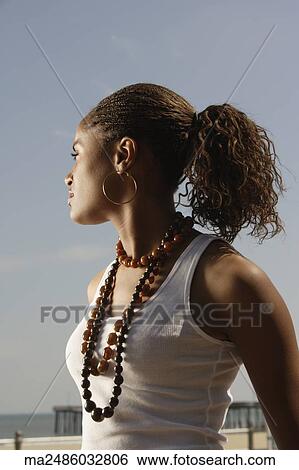 Stock Photograph - Young African woman at beach. Fotosearch