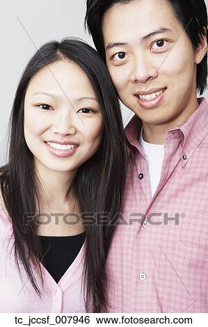 Stock Photograph - Young Asian couple smiling. Fotosearch